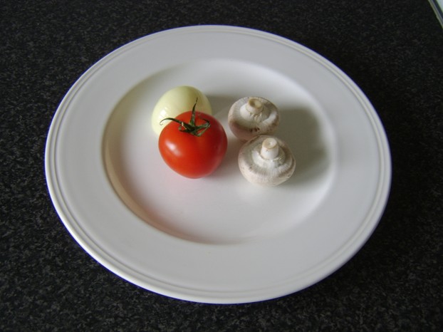 Two small closed cup mushrooms one small tomato and half a white onion