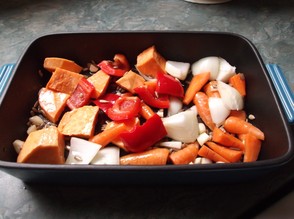 Place the vegetables and sunflower seeds into a roasting pan.