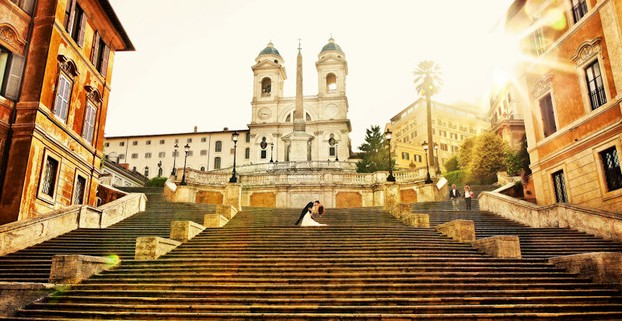 Newlyweds pose for photographs on the Spanish Steps, Rome