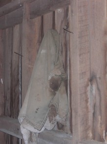 A Winter Coat Hangs Inside the Abandoned Barn