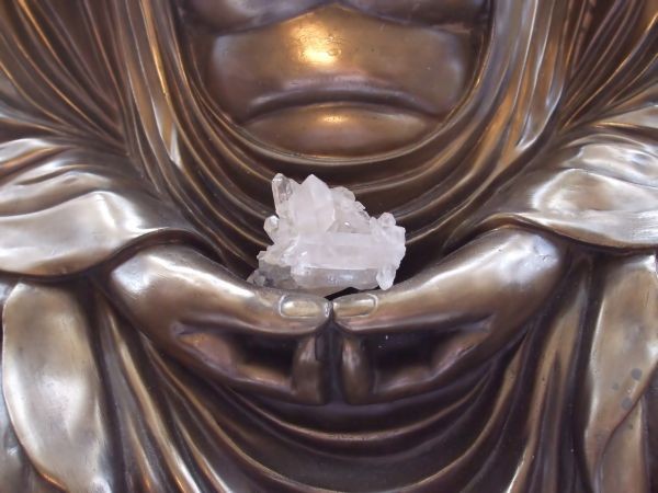 Buddha holding a crystal for meditation
