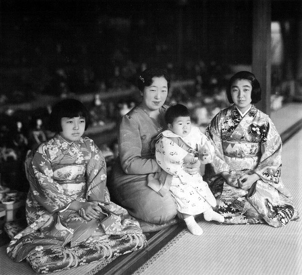 Empress Kōjun (March 6,1903–June 16, 2000) with princesses and tiered dolls during Japan's annual Doll Festival, c1940