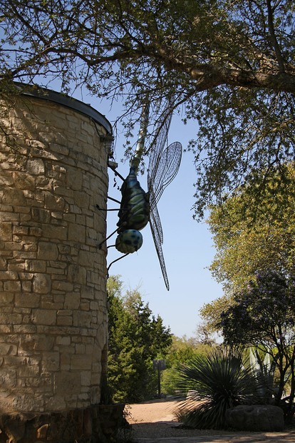 giant dragonfly sculpture on side of stone water cistern tower, Lady Bird Johnson Wildflower Center, Austin, Texas