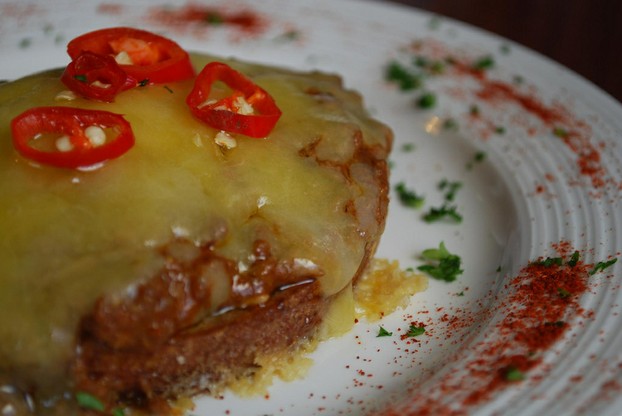 Chili beef in rich paprika spiked sauce atop rye toast, and smothered with cheddar cheese.