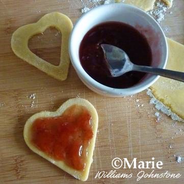 Adding in Jam Jelly Fruit Preserve to the Cookie Hearts