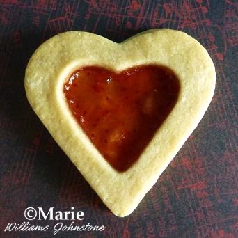 Add strawberry jelly jam preserve to the middle of heart cookies for a delicious sweet treat