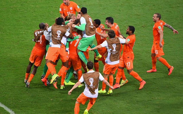 Tim Krul is mobbed by his Dutch team mates after saving the crucial penalty in the quarter finals