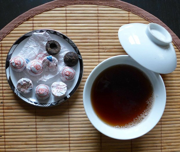 miniature tuocha-shaped pu'er tea cakes with tea infusion