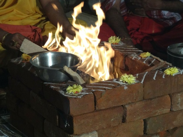 Hindu Preists Offering Ghee To The Fire Altar In A Ceremony