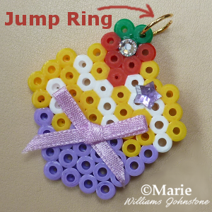 Adding an open jump ring to perler bead design to make jewelry