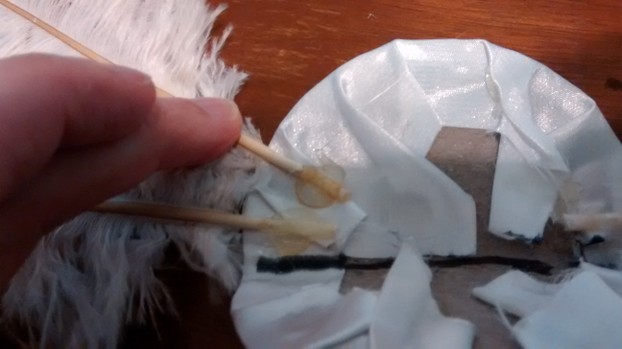 Glue feathers to base.
