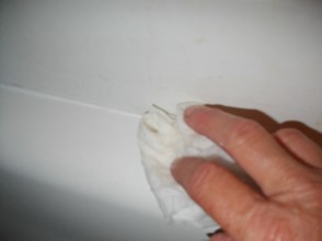 Remove excess caulk with dampened rag