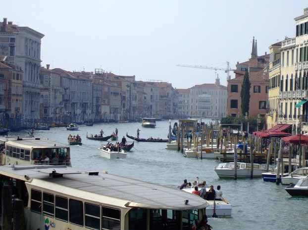 Gondolas, motor boats and vaporetto water buses crowding the Grand Canal