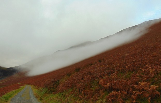 very low  cloud hovers over the fell