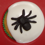 Put the spiders on the cakes