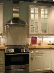 WHite glass door cabinets and stainless range hood