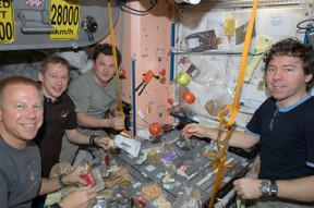 Image: Astronauts on the ISS eating a meal.