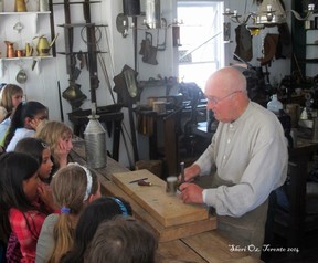 Tinsmith shows class how he works.