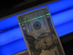 U.S. $20 bill under blacklight