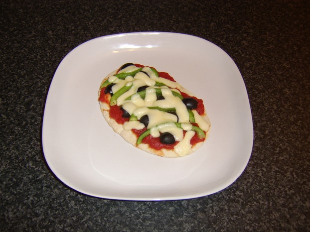 Green bell pepper and black olive pitta bread pizza ready to serve