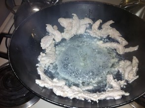 Once chicken is cooked push up to the sided of wok