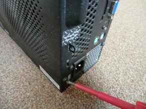 Image: Opening a PC case with a screwdriver