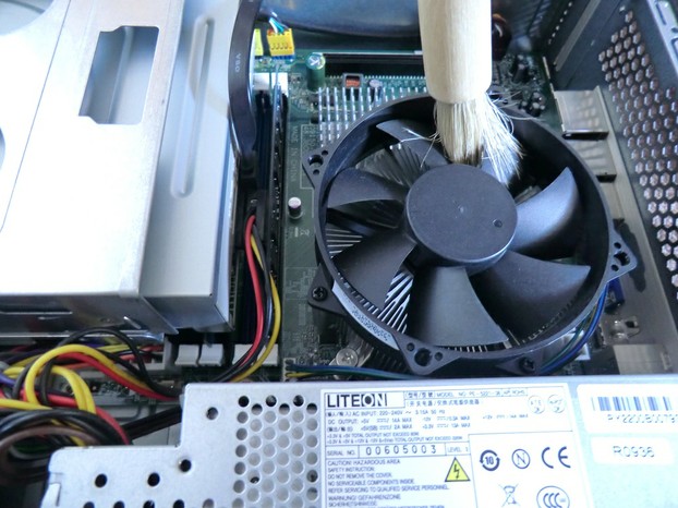 Image:  Dusting a computer with a pastry brush.