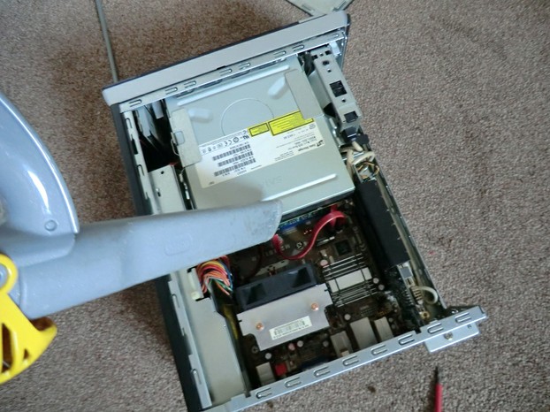 Image: Using a plastic vacuum cleaner to dust a PC.