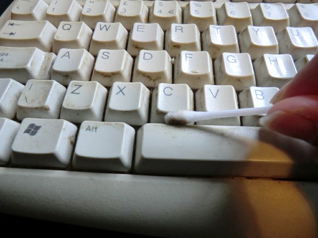 Image:  Using a cotton wool swab to clean a PC keyboard.