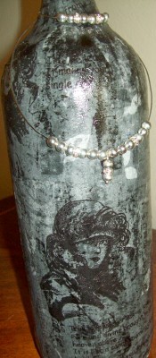 This empty wine bottle is all dressed up with some tissue paper and silver beads.