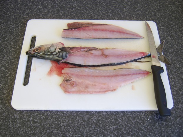 Second fillet is removed from the mackerel