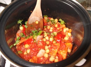 Transfer the vegetables to a pan and chickpeas and tomatoes.