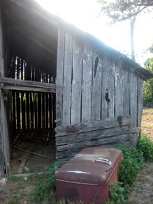Antique Refrigerator Next to the Old Barn