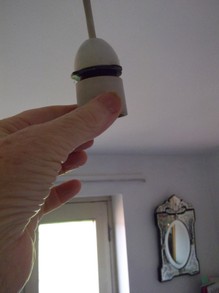Unscrew bottom half of light bulb holder