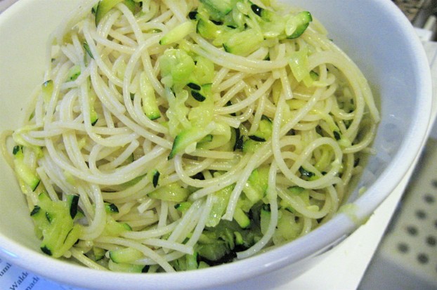Sautéed shredded zucchini serves as colorful complement to long pasta.