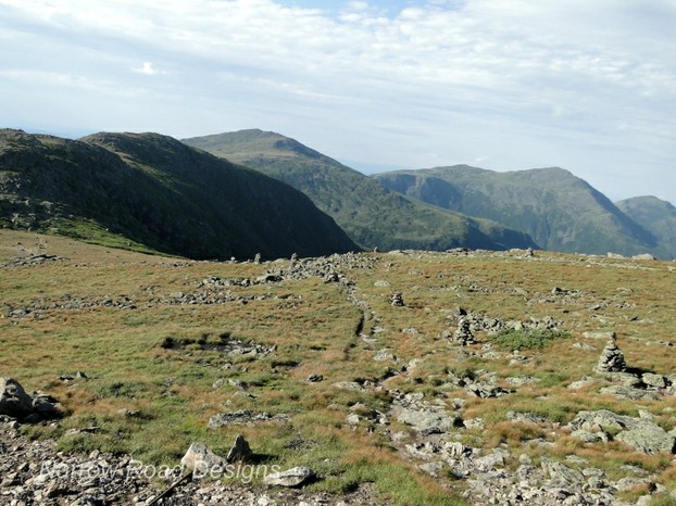 Groups of cairns across the rocky surface at the top.