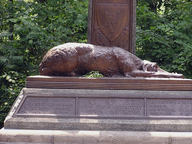 bronze Irish Wolfhound at foot of Celtic Cross; Harp of Erin and American eagles in medallion