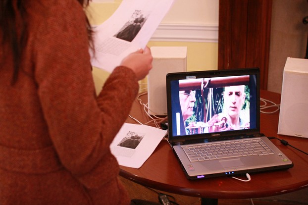 CU psychology student Ashley Duenas holds Soldier's self-portrait with TEO's JoJo; TEO founders Lair and Sulzer on laptop screen