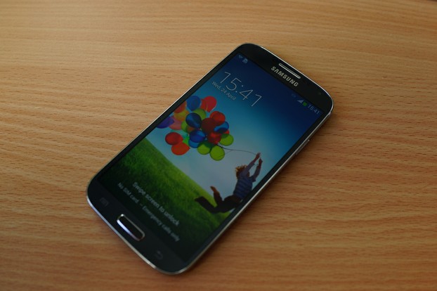 Samsung Galaxy S4 with popular S4 wallpaper of child playing with colorful balloons