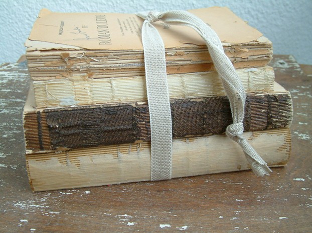pile of books as door stop: also tethered with recycled ribbon