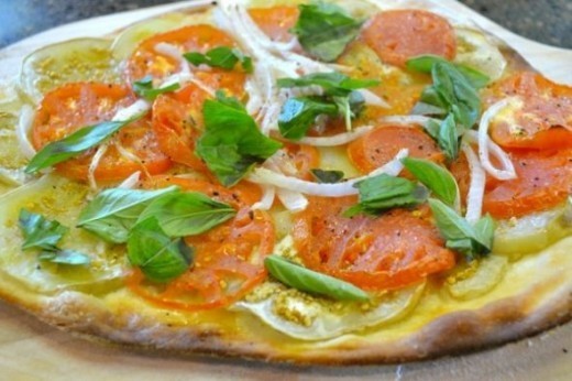 Here I've built a yummy pizza starting with sliced eggplant rounds and then sliced tomatoes, dressed with thinly sliced