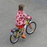 A little girl on a bike