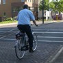 In a suit, on a bike. A normal way of getting to work.