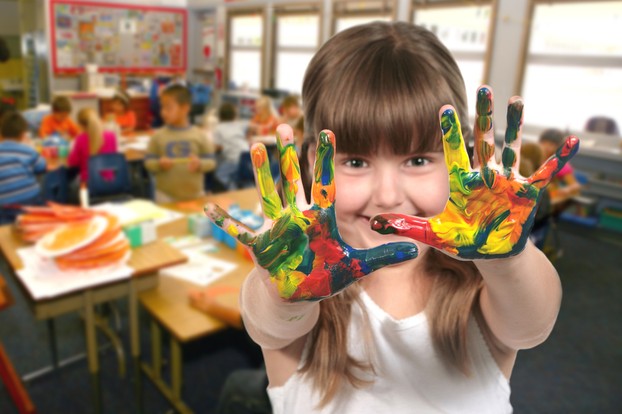 School Age Child Painting With Her Hands