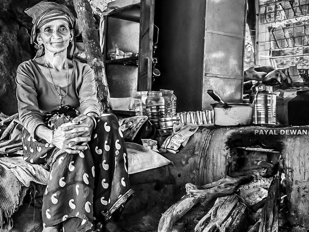 Chai walli (female tea vendor) happily sells tea to travellers on highway in Pauri, Uttarakhand, North India; Friday, June 6, 2014, 23:44:58