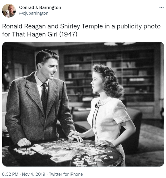 Over a jigsaw puzzle, Tom Bates (Ronald Reagan) offers to pay for college for Mary Hagen (Shirley Temple) in That Hagen Girl.