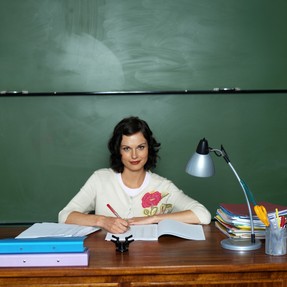 Female Teacher At Desk
