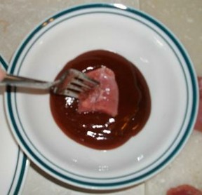 Dip pork loin bites into BBQ sauce
