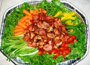 Appetizer tray with pork loin bites and fresh vegetables